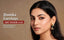 Indian model wearing a gold-toned peacock enamel jhumka earring — Nuyug anti-tarnish jhumka banner