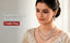 Modern Indian woman in ivory silk blouse with gold thread work wearing the Nuyug American Diamond Elan Grace Layered Necklace Set with matching drop earrings