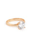 A gold-toned solitaire ring featuring a brilliant round-cut AAA cubic zircon stone on a sleek band