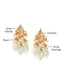 A gold-toned drop earrings featuring a kundan centre piece, light green bead drops, and pearl drops