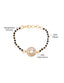 A gold-toned mangalsutra bracelet featuring an oval-cut AAA cubic zircon stone with traditional black beads